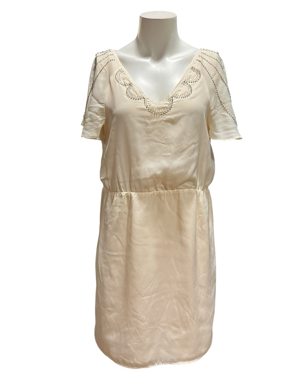 Paraella cream color knee-length dress features delicate beading around the neck